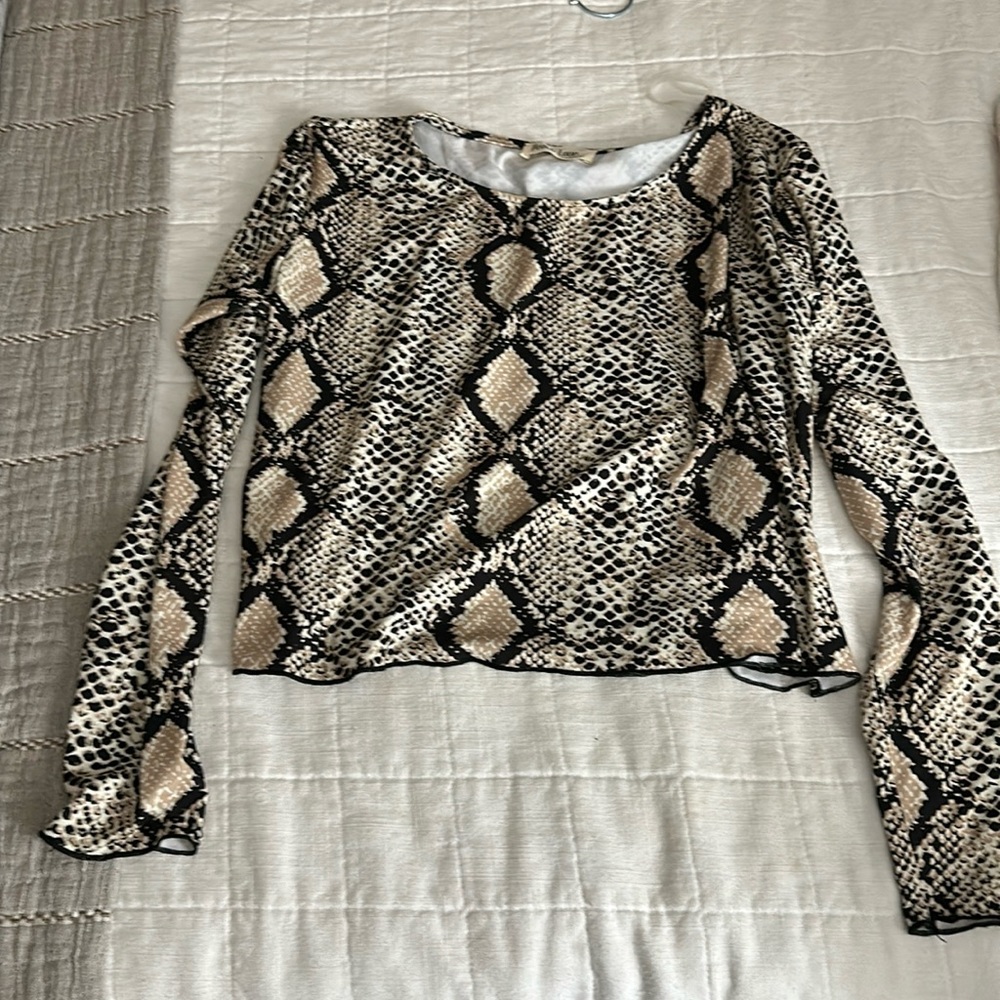 Animal print size small. Cute fit. A little cropped, but covers stomach